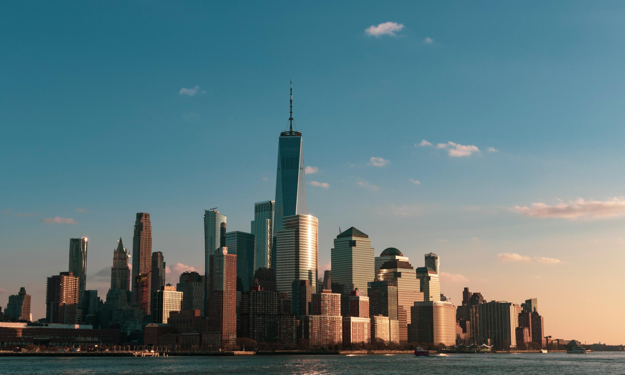 Stunning view of New York City skyline during sunset, highlighting iconic skyscrapers.